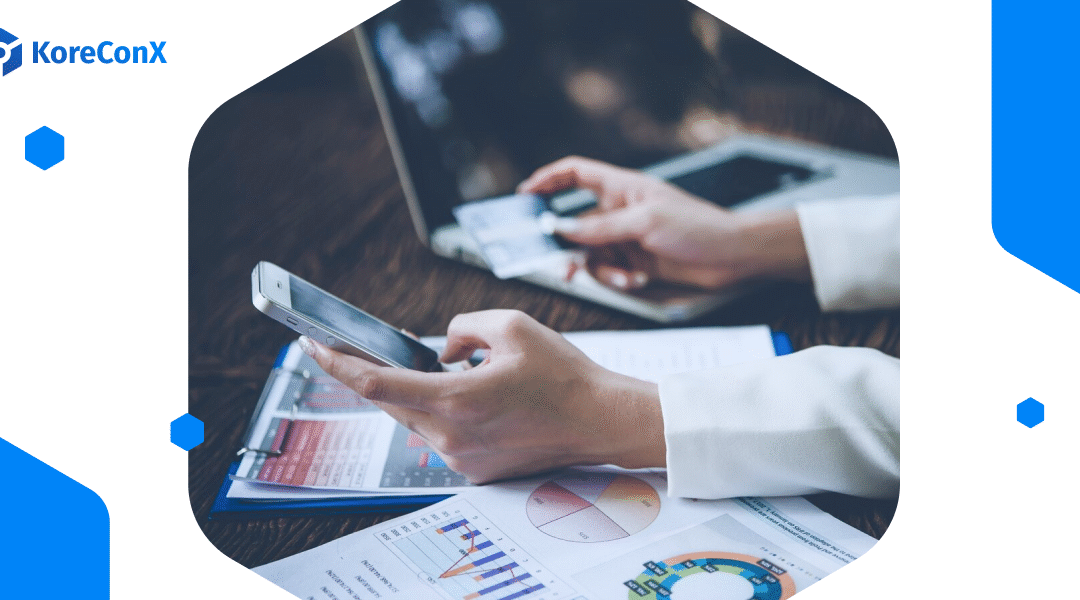 a person holding a mobile device reviewing documents